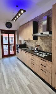 a kitchen with wooden cabinets and a stove top oven at TSUKI House in Marino