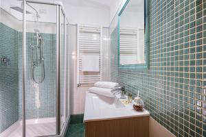 a bathroom with a sink and a shower and a mirror at Affittacamere Guest House Glatimia in Rome