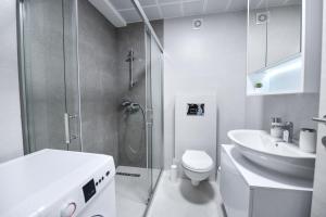 a bathroom with a shower and a toilet and a sink at St'Petar apartment in Skopje