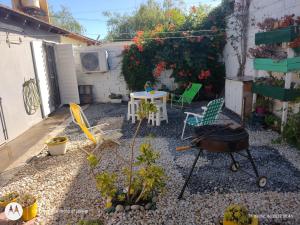 a garden with a table and chairs in a yard at Mi casita in Tandil