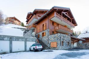 a house with a car parked in front of it at Bel appartement au calme vue vallée in Sainte-Foy-Tarentaise