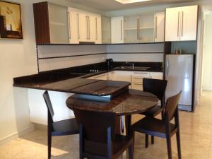 a kitchen with a table and chairs and a refrigerator at AMAZING BIG APARTMENT IN SOUTH PHUKET in Phuket Town