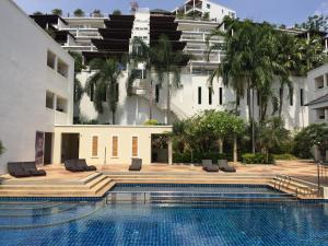 a hotel with a swimming pool and a large building at AMAZING BIG APARTMENT IN SOUTH PHUKET in Phuket Town