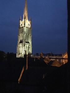 a tall building with a clock tower at night at Rooftops in Louth