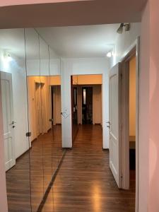 a hallway with a mirror on the wall at Majestic Luxury Apartment Close to Presidential Palace in Bucharest