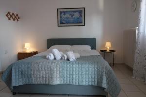 - une chambre avec un lit et 2 serviettes dans l'établissement Kiki's cosy apartments, à Néa Khilí