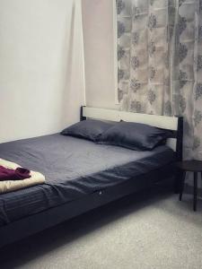 a bed sitting in a bedroom with a curtain at Krishna Homes in Bangalore +21 photos