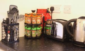 a counter with spices and a toaster and a tea kettle at The Annexe in Thorpe