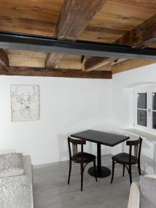 a dining room with a black table and chairs at 24-7 Apartment Passau in Passau