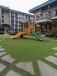 a playground with a slide in a yard at KILA Homes at Pine Suites Tagaytay in Tagaytay