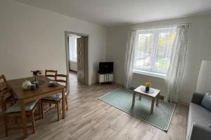 uma sala de estar com uma mesa e uma sala de jantar em Dům nad jezerem - apartmán II. em Most
