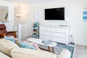 a living room with a couch and a tv at Seaview Duplex 6 & 7 in Kure Beach