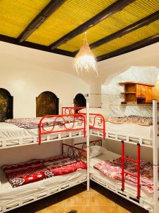 two bunk beds in a room with a ceiling at Azoul Surf Hostel Taghazout in Taghazout +66 photos