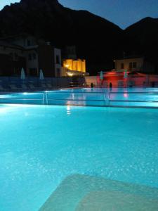 a large pool of blue water at night at Hotel Terme di Frasassi in Genga