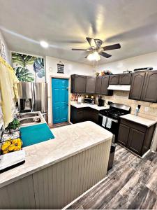 a kitchen with a sink and a ceiling fan at Delightful Empowerment Palace in Philadelphia