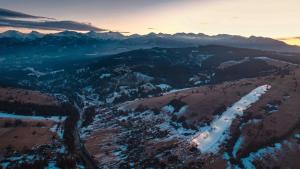 an aerial view of a mountain range with a road at Górska Baja Premium House in Witów