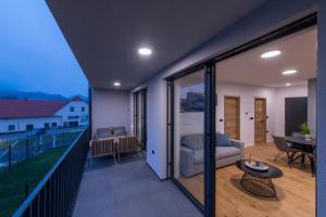 a balcony with a couch and a table at Apartmaji Harpf in Slovenj Gradec