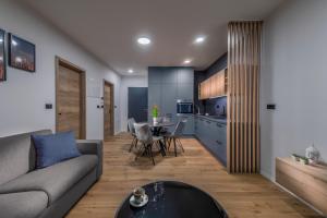 a living room with a couch and a table at Apartmaji Harpf in Slovenj Gradec