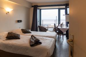 Postel nebo postele na pokoji v ubytování Hotel Les Mouettes