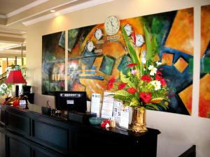 a large painting of a clock on a wall at Bali Paradise Hotel Boutique Resort in Lovina +87 photos