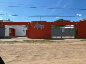 a red building with a shark painted on it at Apart Alto Parana in Paso de la Patria