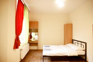 a small bedroom with a bed and a window at Doba In Ua Studio Irpin Apartments in Irpin