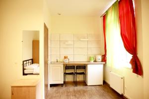 a small kitchen with a counter and a table at Doba In Ua Studio Irpin Apartments in Irpin'
