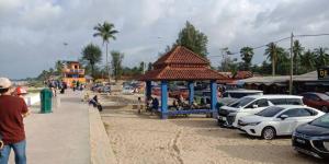 a gazebo with cars parked in a parking lot at PCB PURPLE GUEST HOUSE in Kota Bharu