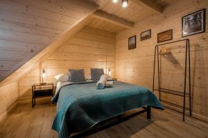 a bedroom with a bed in a wooden cabin at Apartamenty na Polnej in Leśnica