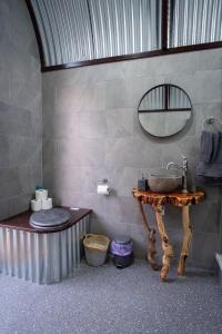 a bathroom with a sink and a toilet and a table at Get Away Hide Away in East Dereham