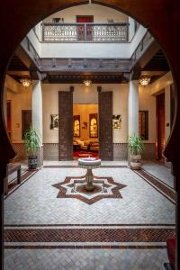 a courtyard with a fountain in the middle of a building at Riad & Spa Bahia Salam in Marrakesh