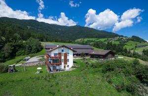 an aerial view of a house on a hill at Oberhauser Hof - Apartments in Feldthurns