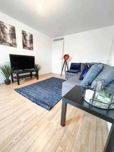 a living room with a couch and a table at Spacious Two Bedroom flat in Hither Green