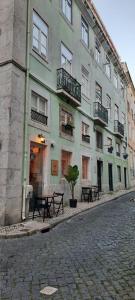 een gebouw op een straat met tafels ervoor bij Lisbon Historical Center renewed apartment in Lissabon