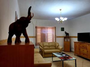 uma sala de estar com uma estátua de um elefante sobre uma mesa em WatAir House Apartman Sarud em Sarud