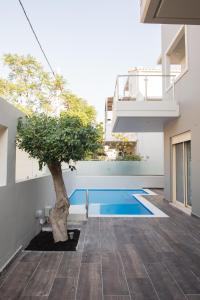 a courtyard with a tree in the middle of a building at Palmyra Athens in Athens