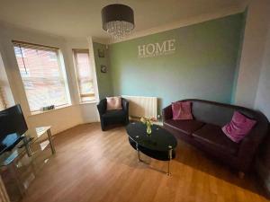 a living room with a couch and a table at Wilce House in Wellingborough