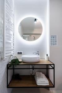 a bathroom with a sink and a mirror at AZURE PREMIUM Dreams in Kołobrzeg