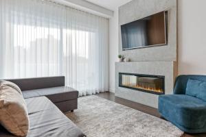 a living room with a couch and a fireplace at Initial / Saphir / Québec in Quebec City