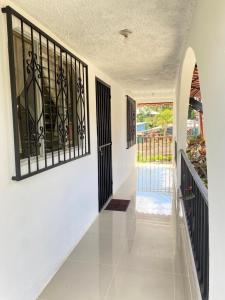 a hallway of a house with black iron gates at Agutí Apartment in Manuel Antonio