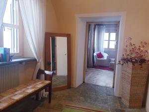 a living room with a bench and a mirror at Palazzo Mysanus Samedan in Samedan