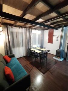 a living room with a couch and a table at Cabaña en playa San Ignacio in Valdivia