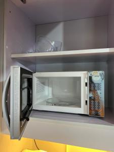 a microwave oven with its door open in a kitchen at City Center - front of Iloilo Esplanade 2BR condo in Iloilo City