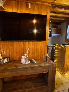 a large flat screen tv on a wooden wall at Chalet Cosy Les Gets Vue Montagne in Les Gets