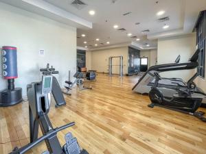 a gym with a treadmill and a elliptical machine at Elegant Studio with Canal View and Close to Metro in Dubai