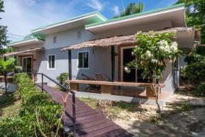 ein kleines weißes Haus mit einer Terrasse in der Unterkunft Harmony Naturist Resort Rawai Phuket 18yr minimum age only nudist nake d FKK in Rawai Beach