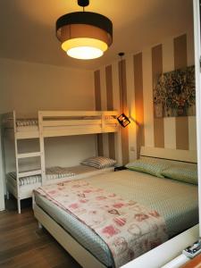 a bedroom with two bunk beds and a light at Appartamento la Canvetta in Santa Maria Maggiore