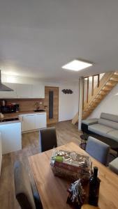 a kitchen and a dining room with a table and chairs at Apartments Ela in Rateče