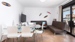 a dining room with a glass table and white chairs at Paradise Island in Lajares