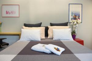 a bedroom with a bed with two towels on it at Strovolos Value Suites in Strovolos